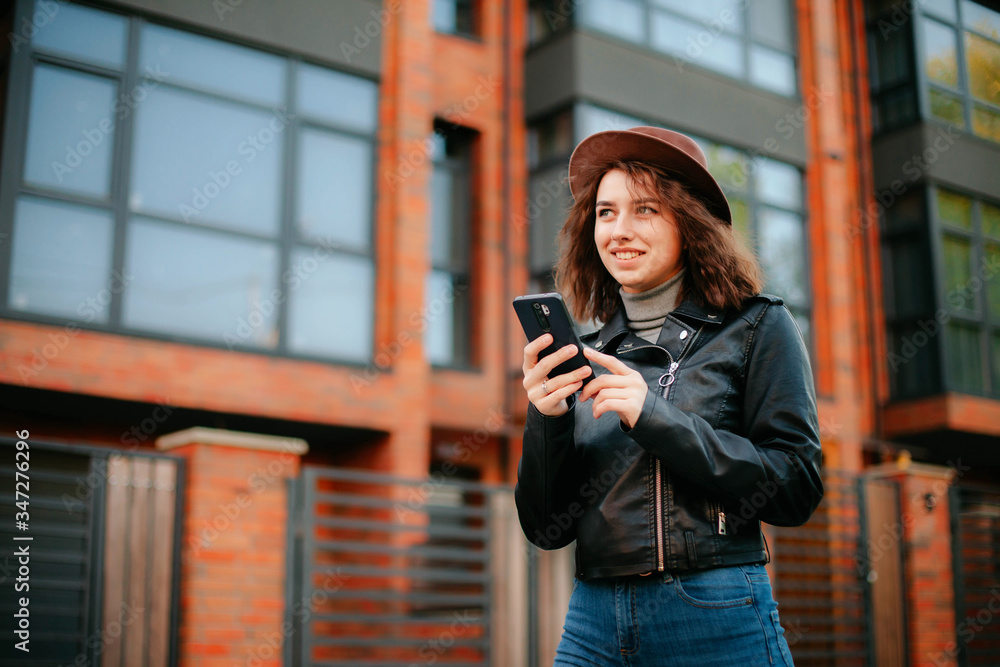 © Kateryna Ivaskevych - young woman with mobile phone in the city. coronavirus. covid-19.