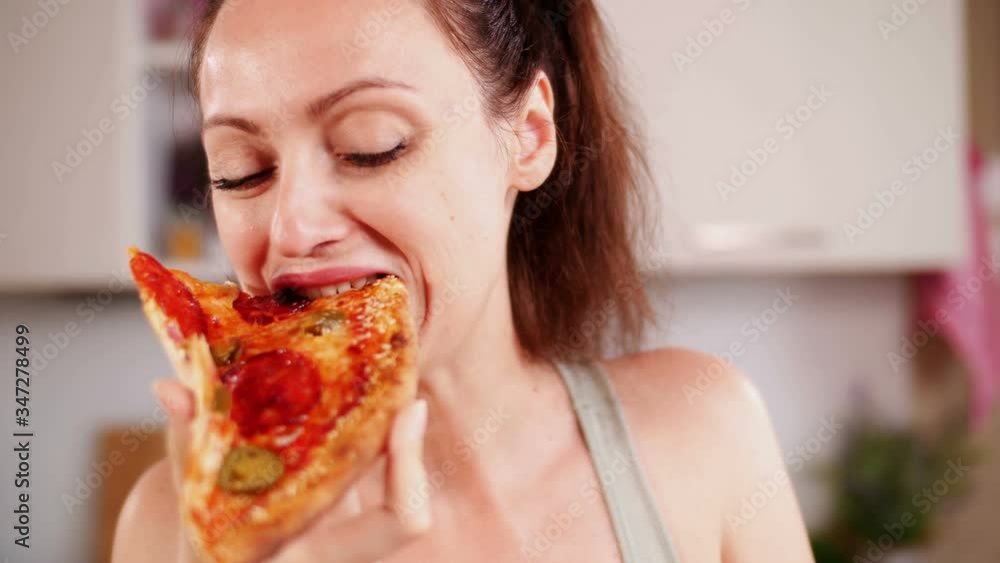 Beautiful girl eating piece of pizza Beautiful girl eating piece of pizza