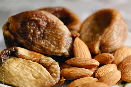 Raw almonds and figs on a plate