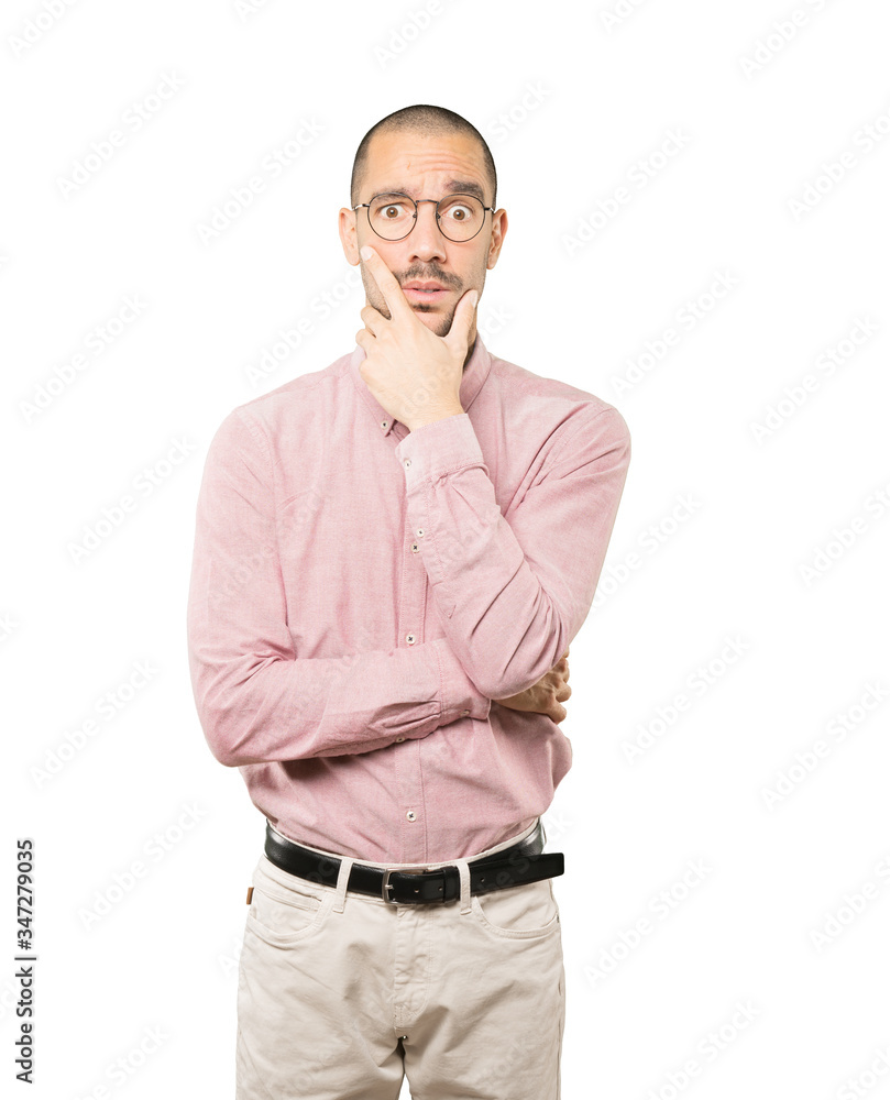 Concerned young man posing against background Concerned young man posing against background