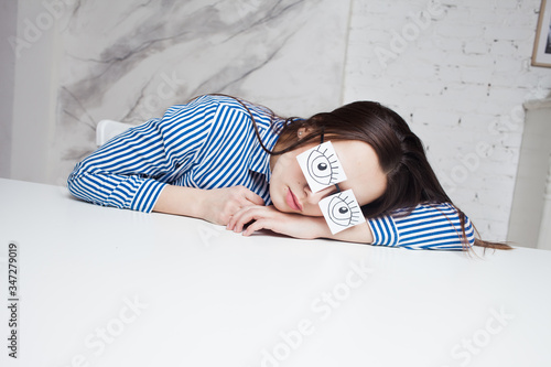 Fotografie Drowsiness and procrastination. A student pretends to work,
