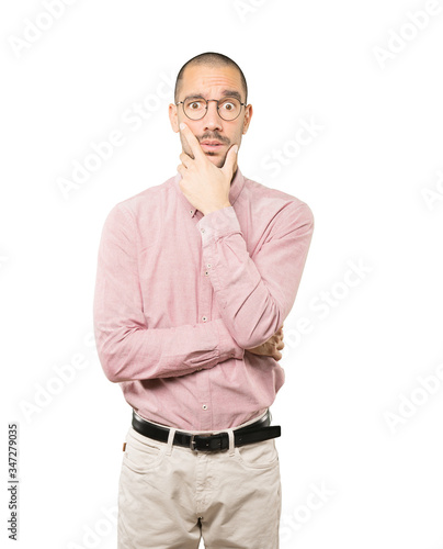 Concerned young man posing against background © agongallud