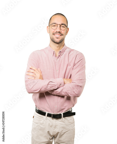 Satisfied young man with crossed arms gesture