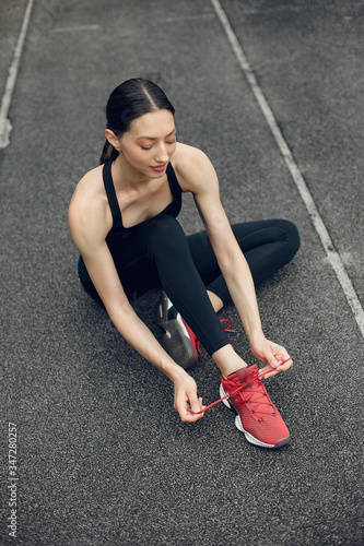 Beautiful girl at the stadium. Sports girl in a sportswear.