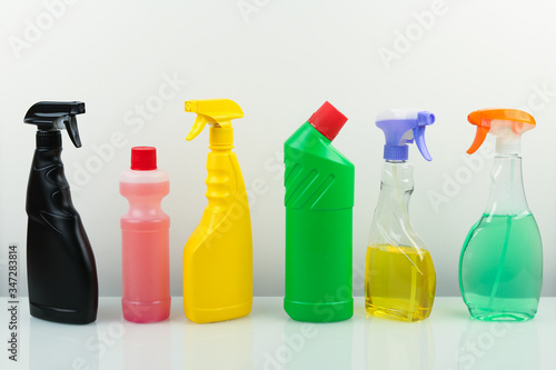 set of different bottles with cleaning products on white background