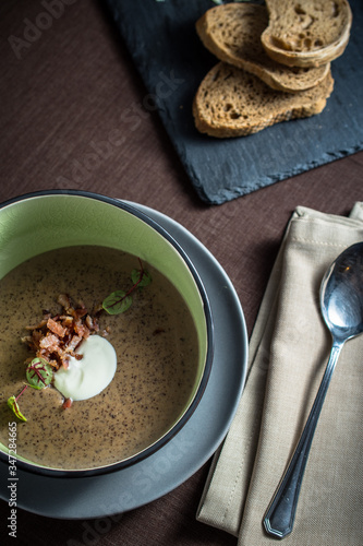 Vegetable cream soup with bacon and sour cream