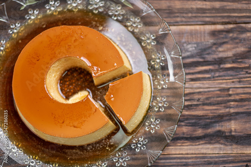 Milk Pudding or Pudim de leite. Brazilian dessert homemade caramel custard pudding. Traditional brazilian flan on wooden background