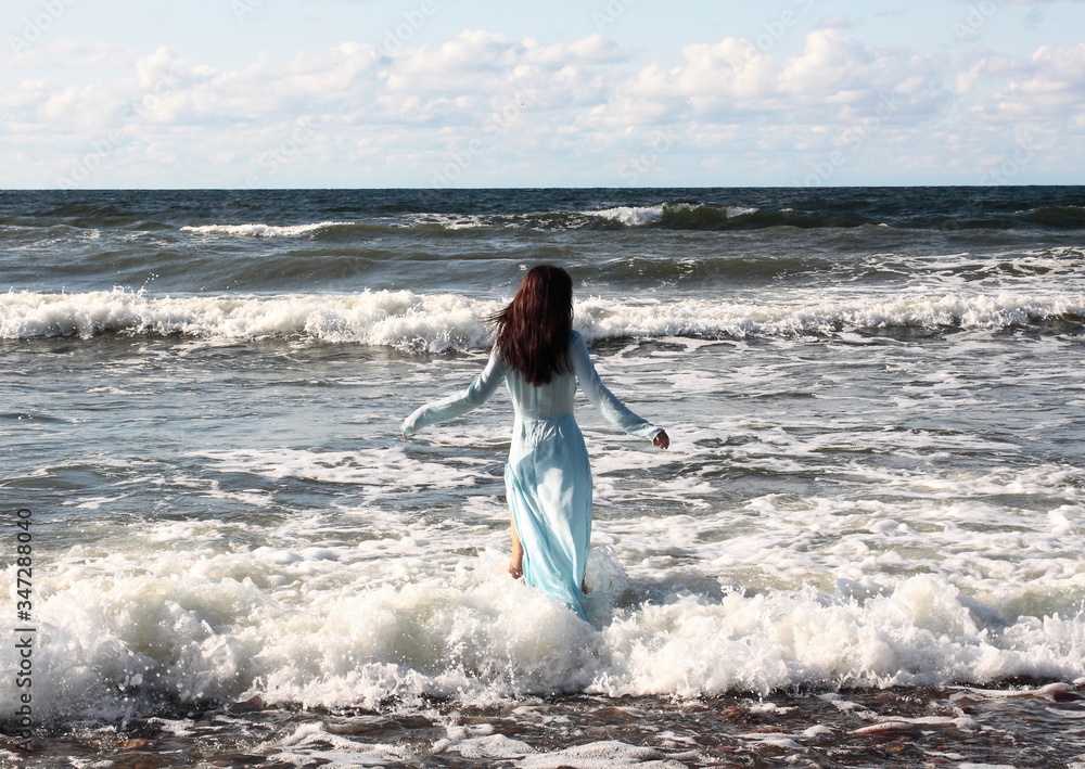 Fototapeta premium Baltic sea coast. Russia. Girl in blue
