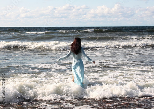 Baltic sea coast. Russia. Girl in blue