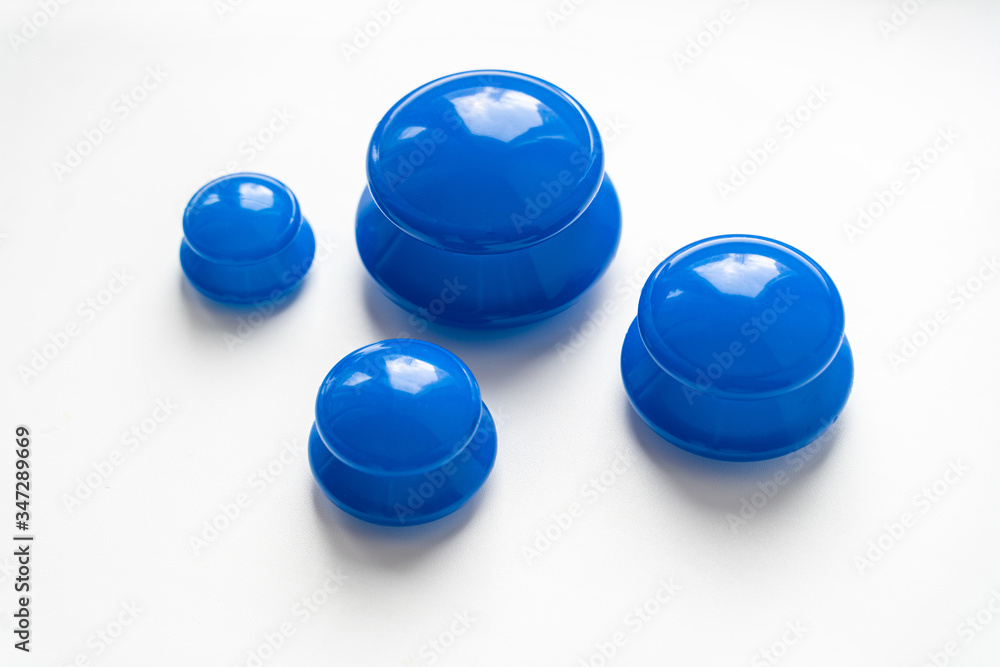 Silicone vacuum jars, banks for massage, anticellulite, face fitness, blue, on a white background Silicone vacuum jars, banks for massage, anticellulite, face fitness, blue, on a white background