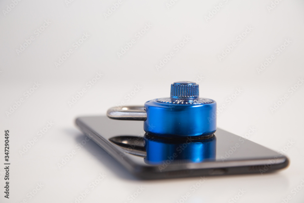 abstract  digital devices detox, Smartphone  unlock metal security lock key on wooden table,Concept: hacker Password for data technology digital crime finance