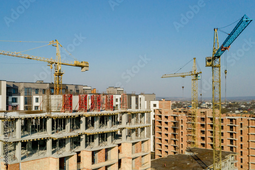 Construction and construction of high-rise buildings, the construction industry with working equipment and workers. View from above, from above. Background and texture
