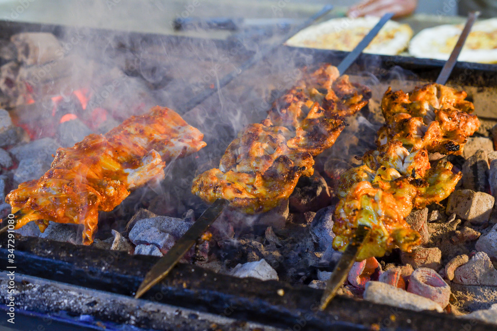 Roasted meat cooked at barbecue. Grilled kebab cooking on metal skewer. BBQ fresh beef meat Roasted meat cooked at barbecue. Grilled kebab cooking on metal skewer. BBQ fresh beef meat