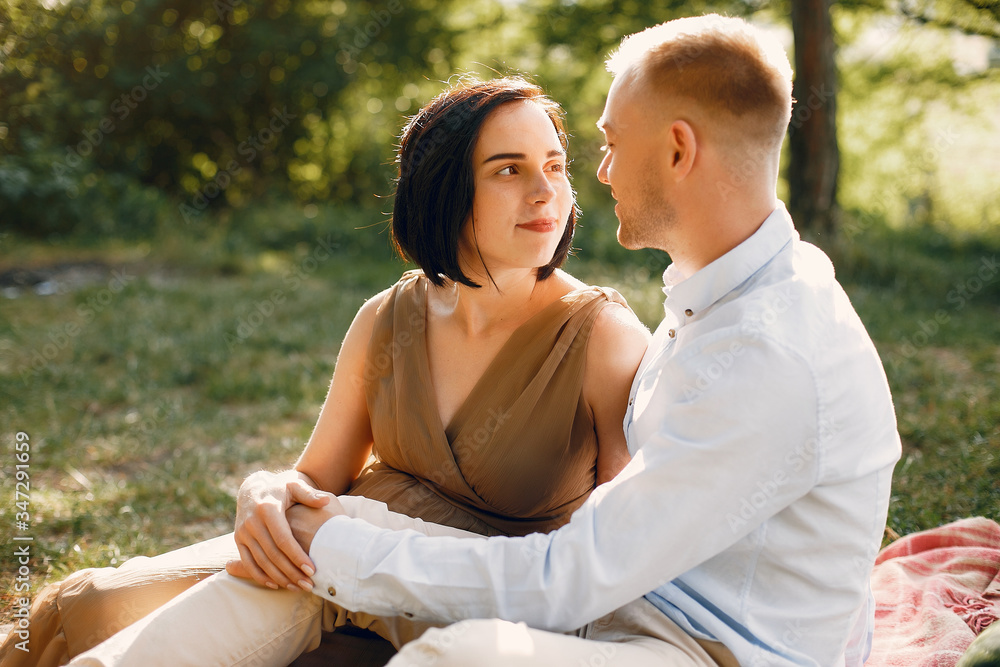 Pragnant woman. Family in a field. Man in a white shirt Pragnant woman. Family in a field. Man in a white shirt