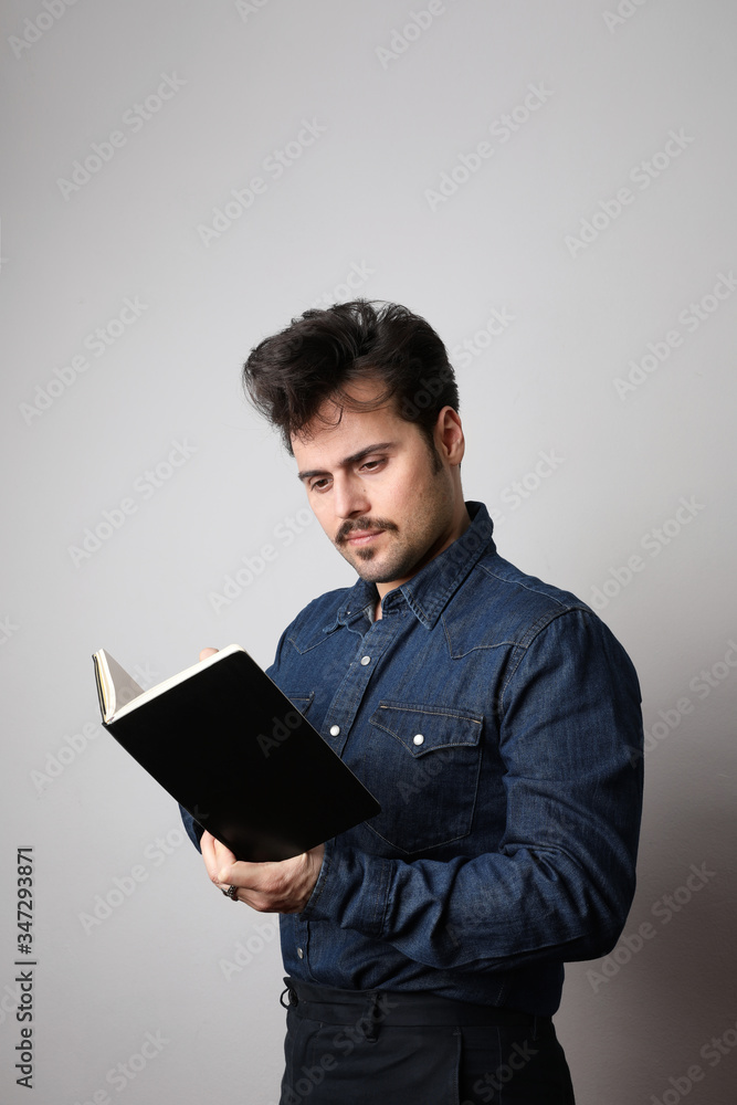 Writing a To-Do List. Handsome mature man In shirt writing something in note pad over white background. Space for text. Writing a To-Do List. Handsome mature man In shirt writing something in note pad over white background. Space for text.