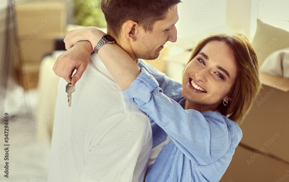 Fototapeta premium Happy couple hugging in their new house