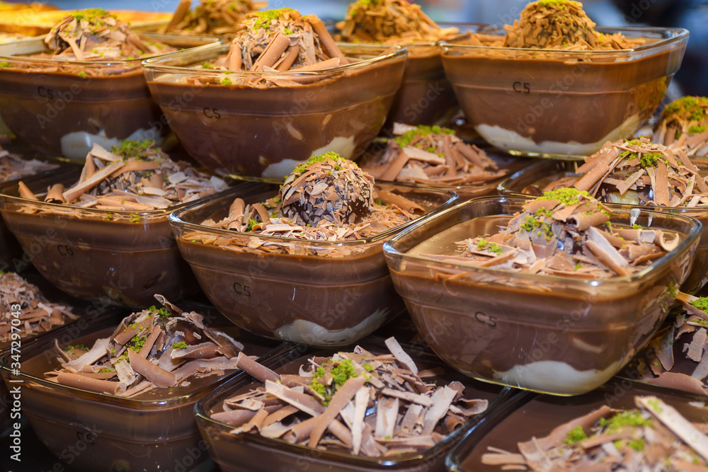 Fototapeta premium Chocolate mousse pudding in portion glasses on stack one over another