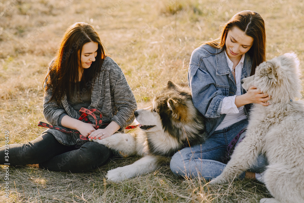 Women in a spring forest. Girls with cute dogs. Stylish friends walks. Women in a spring forest. Girls with cute dogs. Stylish friends walks.