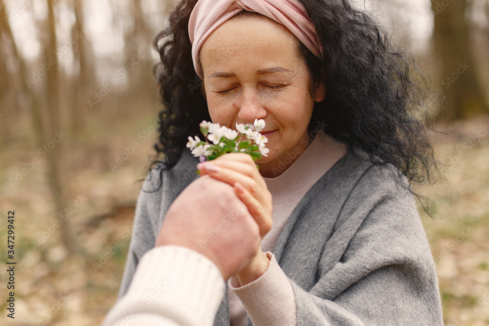 Woman in a forest. Adult lady walks. Woman with bouquet of flowers. Woman in a forest. Adult lady walks. Woman with bouquet of flowers.