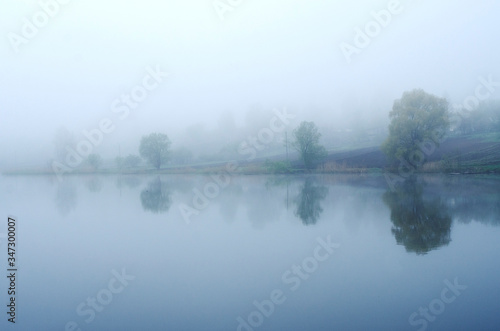 Fog on the lake, cloudy morning, poor visibility and high humidity.