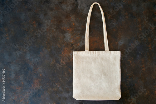 Blank cotton eco tote bag, design mockup. Eco-friendly bag on a black background. photo