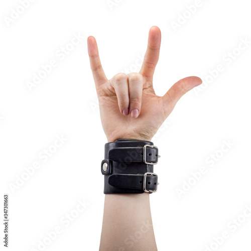 hand with leather rocker bracelet with rock and roll sign, rock music, isolated on white background
