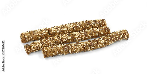 Sesame- linen stick crackers. Pretzel bread stick with sesame and linen, flax seeds isolated on white background.