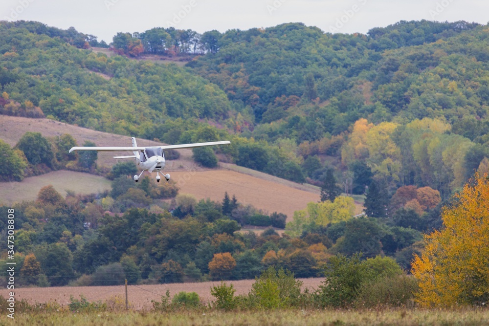 Naklejka premium Airplane landing at small airport