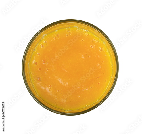Glass of milkshake or cocktail isolated on white background.  Mango, grapefruit, tangerine mix. Top view