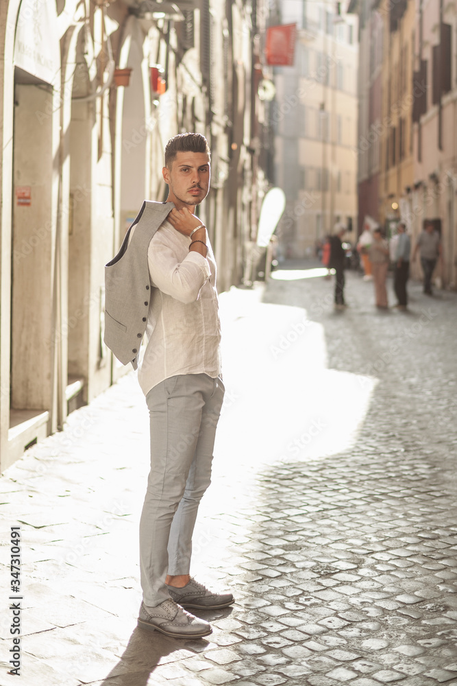 Nice boy posing in Rome during a sunny day untile the sunset