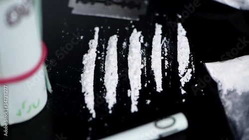 Portion of rotating Cocaine on a dark plate (seamless loopable)