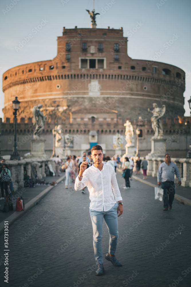 Nice boy posing in Rome during a sunny day untile the sunset