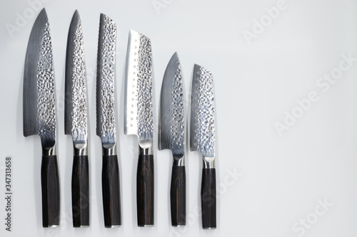 Japanese damascus kitchen knifes on the white backround
