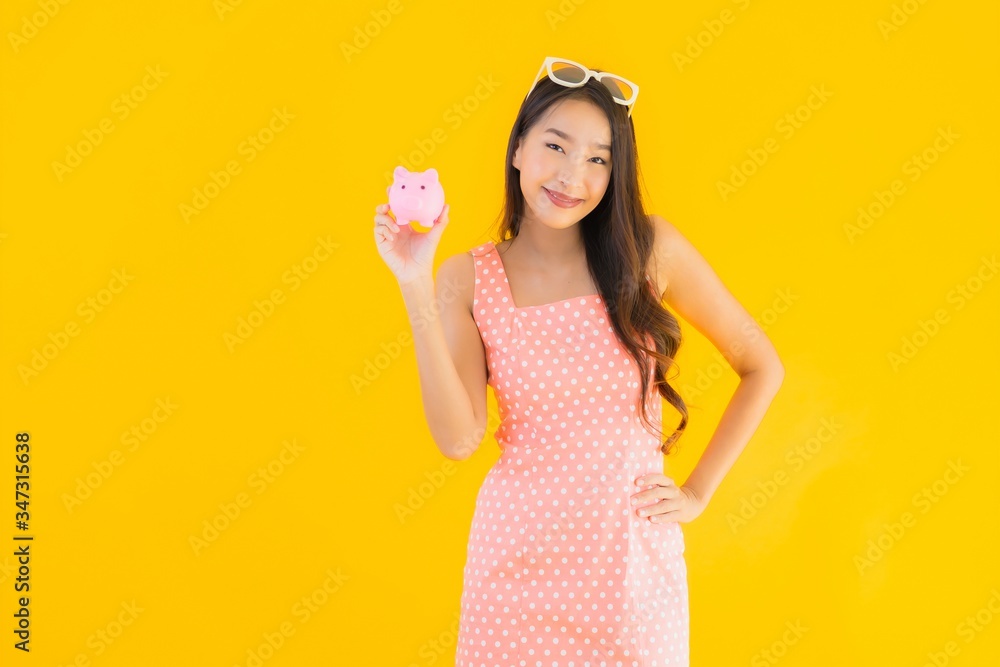 Portrait beautiful young asian woman show a lot of cash or money with piggy bank Portrait beautiful young asian woman show a lot of cash or money with piggy bank