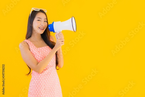 Portrait beautiful young asian woman speak loud with megaphone