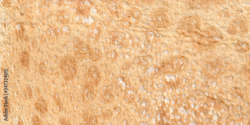 Texture of thin traditional freshly baked homemade italian bread. Close-up pita bread as a textured bread background.