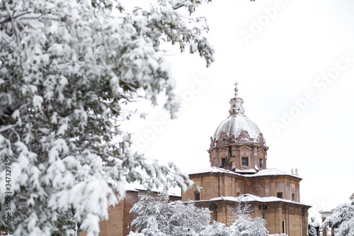 A lovely day of snow in Rome, Italy, 26th February 2018: a beautiful view of snowy Roman Forums and Church of the Saints Luca and Martina under the snow photo