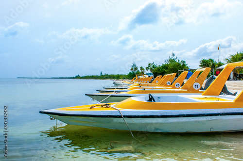 Line-up of high speed boats in water.