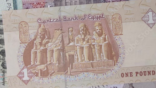 Part of the facade of Abu Simbel Temple. Portrait from Egypt 1 Pound Banknote. A Ramses II in front of the Luxor Temple of Amenophis II. Egypt money. Egypt Banknotes. Collection. rotating banknote photo