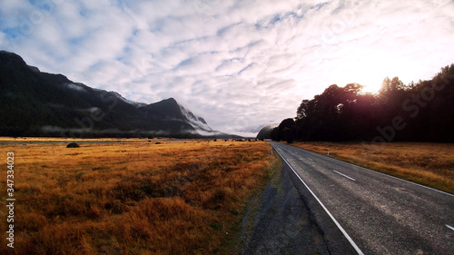 Misty sunrise in the mountains - Route 94, Fiordland National Park, New Zealand photo