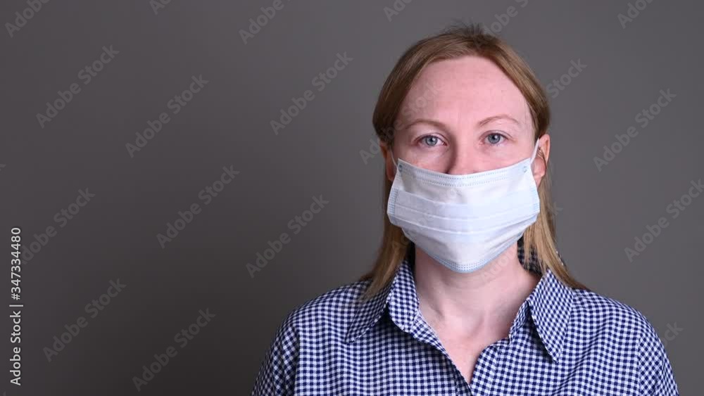 The girl protects herself with a medical mask. Security of the house and surroundings. spread of infection covid The girl protects herself with a medical mask. Security of the house and surroundings. spread of infection covid