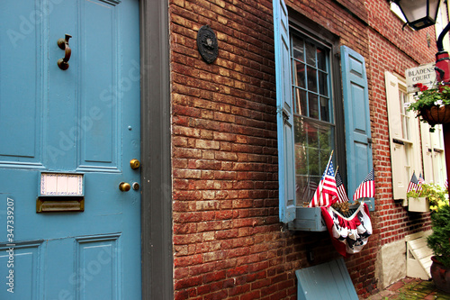 US flags in the window of an apartment building on the oldest street Elfret's Alley in Philadelphia.