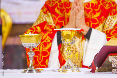 chalice with wine, blood of christ, and pyx with bread, body of christ, ready for the communion of the faithful