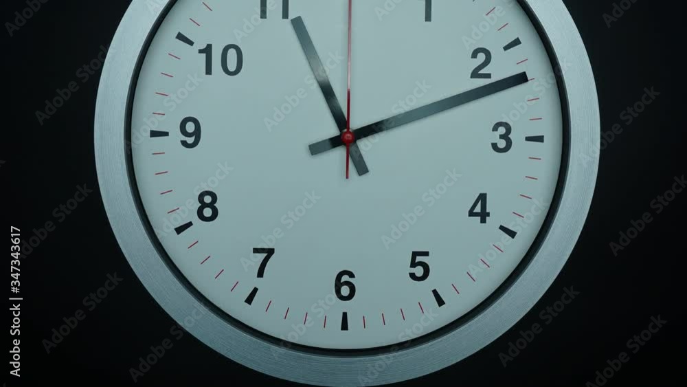 Close up Angle camera from bottom to top, Eleven o'clock Gray wall watch on black background, Time lapse 60 minutes moving fast, Time concept. Close up Angle camera from bottom to top, Eleven o'clock Gray wall watch on black background, Time lapse 60 minutes moving fast, Time concept.