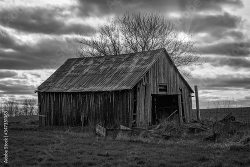 Rural black and white landscapes featuring old barns and farmland with sky and sunset. Ontario Canada