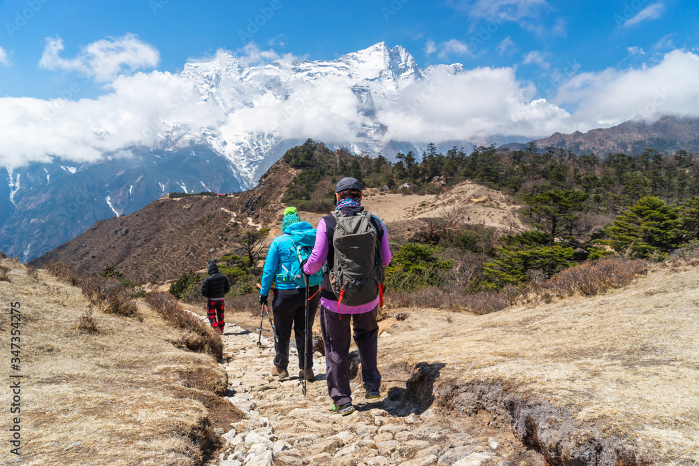 Trekkers walking on Everest base camp trekking trail, Himalaya mountains range in Nepal