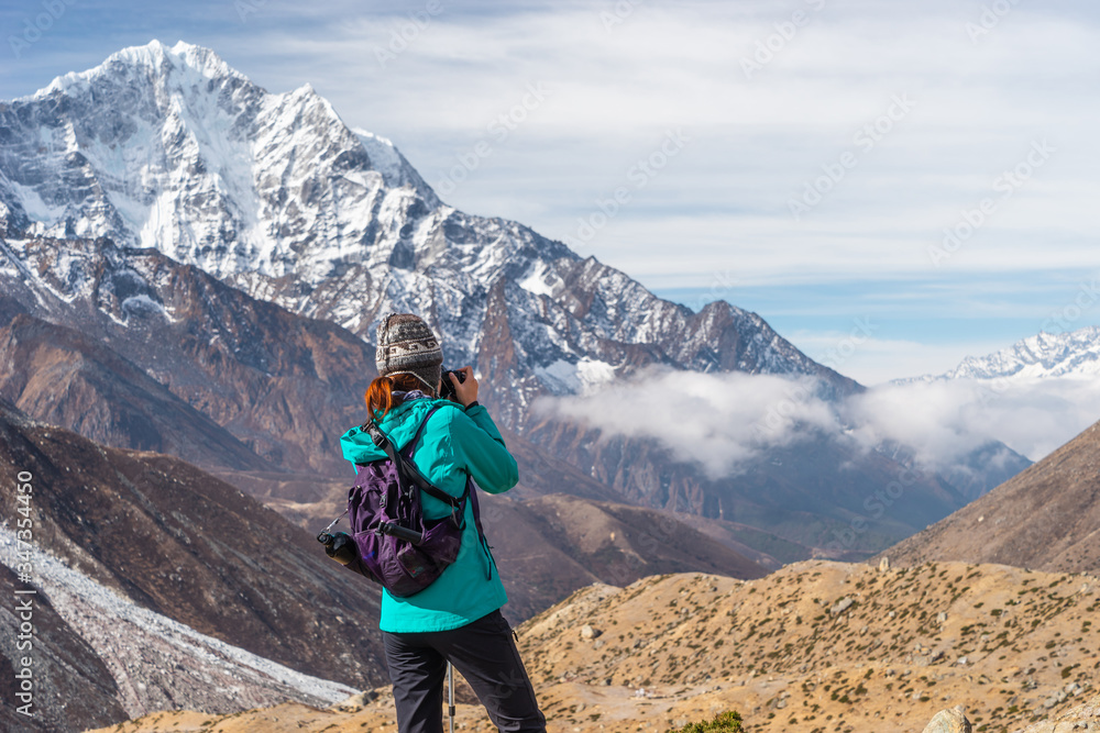 A trekker taking picture of Himalaya mountains, Everest region in Himalaya mountain range in Nepal