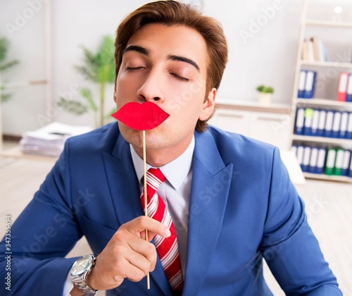 Funny bisinessman with fake lips in the office photo