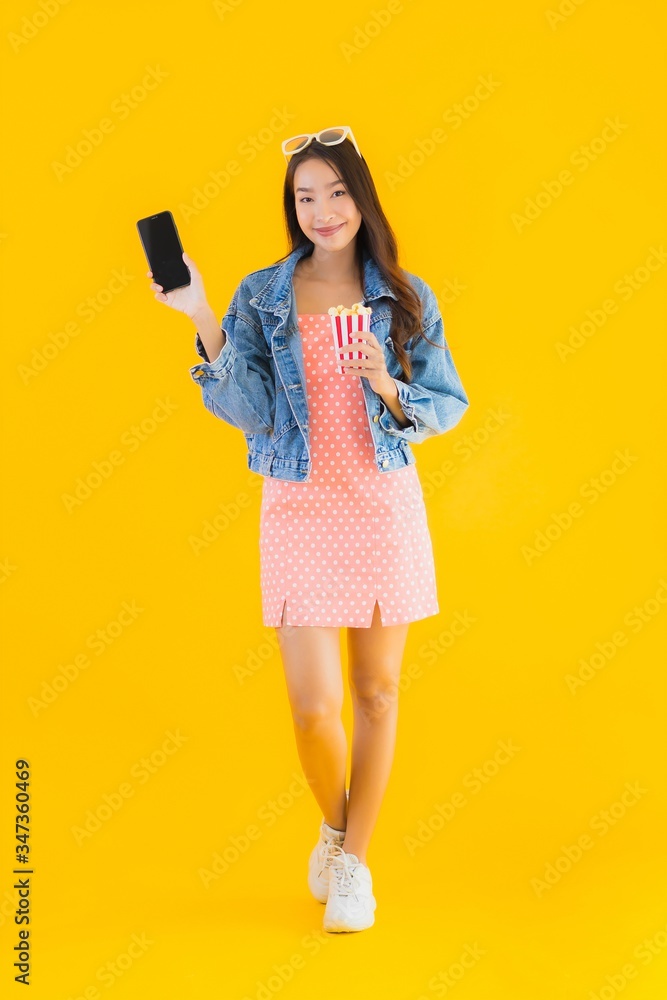 Portrait beautiful young asian woman enjoy happy with phone popcorn and watch movie Portrait beautiful young asian woman enjoy happy with phone popcorn and watch movie