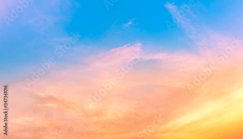orange light in dust pink clouds with blue sky © Passakorn